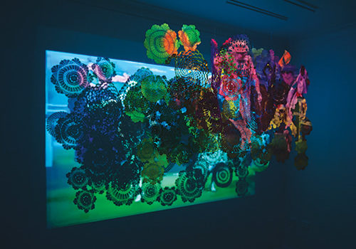 Kiri Morcombe, There’s something about pattern I, 2011, doilies and video, dimensions variable, photo by Alex Wissser